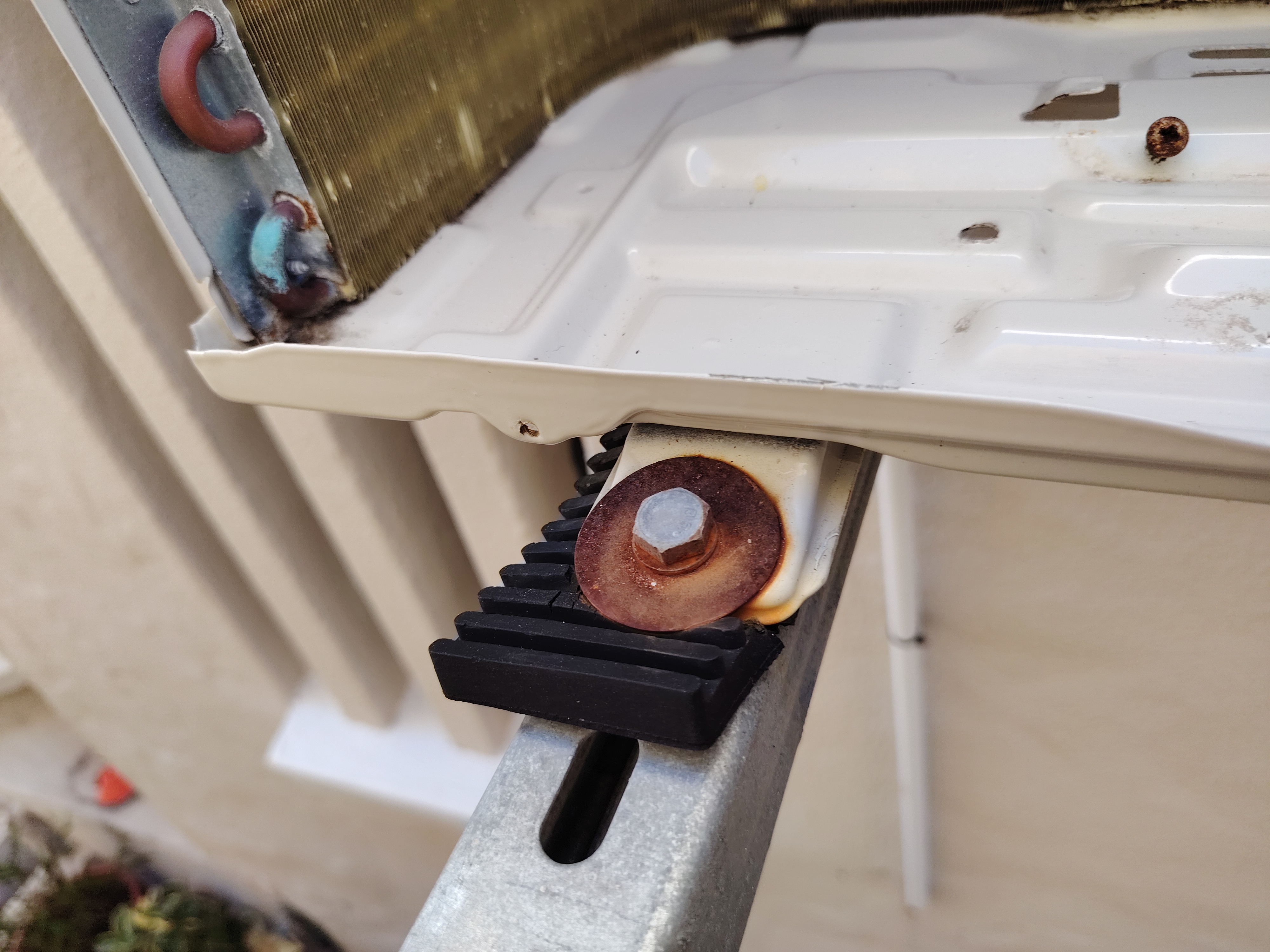 Corroded outdoor air conditioning cabinet being carefully cleaned and prepared