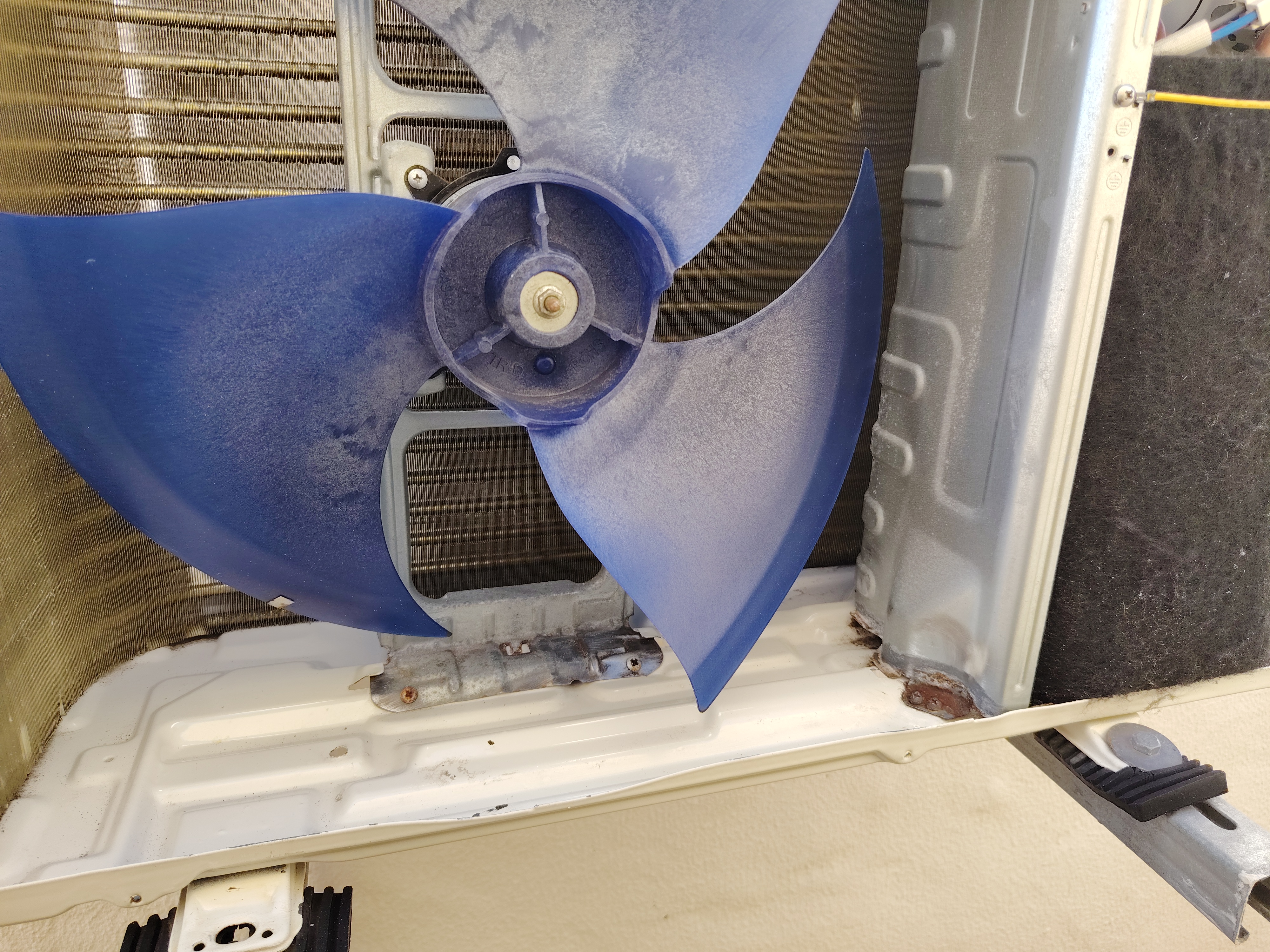Outdoor air conditioning unit stripped for detailed corrosion removal