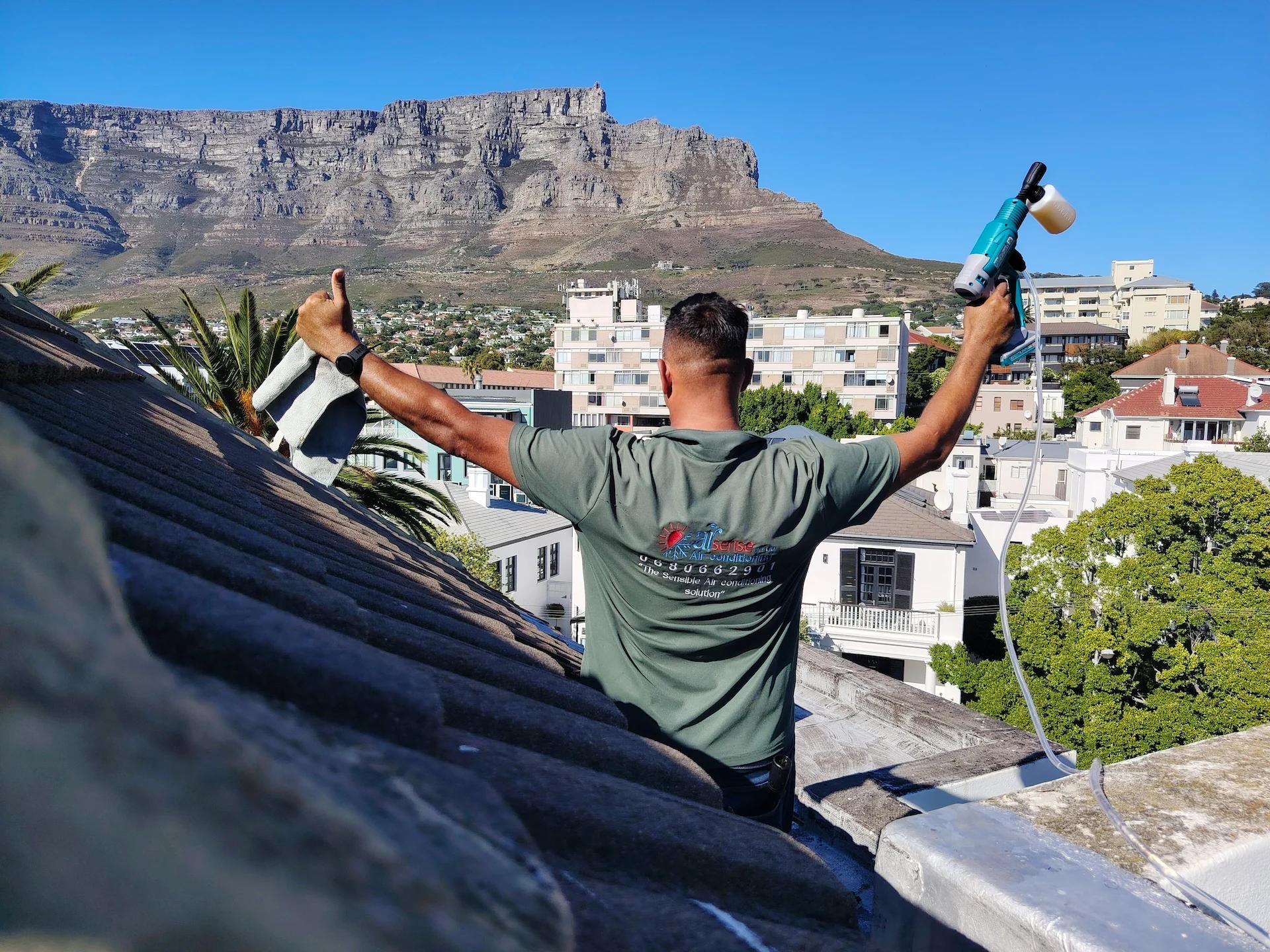 Airsense air conditioning technician working in Cape Town with Table Mountain in the background